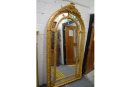 A GOOD LARGE GILT FRAMED ARCH TOPPED MIRROR 225cm high x 115cm wide.