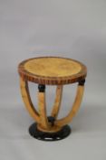 AN ART DECO DESIGN BLOND WOOD AND ROSEWOOD GRAINE CIRCULAR OCCASIONAL TABLE on four curving supports