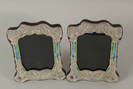 A PAIR OF SILVER AND ENAMEL BUTTERFLY PHOTOGRAPH FRAMES. 21cms x 14cms.