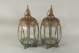 A PAIR OF METAL GLAZED CROWN TOP LANTERNS. 60cms high.