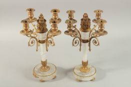 A GOOD PAIR OF CRYSTAL AND ORMOLU FOUR BRANCH CANDELABRA on circular bases. 37cm high.