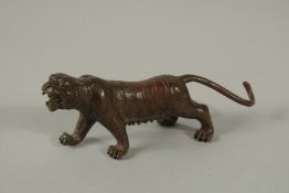 A BRONZE TIGER. 13cms long.