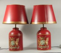 A PAIR OF RED TOLEWARE CANNISTERS converted to lamps with shades.