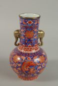 A CHINESE BLUE GROUND COPPER RED PORCELAIN VASE with moulded elephant head handles and painted