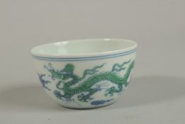 A CHINESE PORCELAIN DRAGON CUP character mark to the base. 7.5ins diameter.