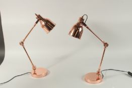 A SMALL PAIR OF COPPER ANGLE POISE LAMPS.