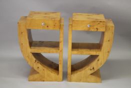 A PAIR OF ART DECO DESIGN BLOND WOOD BEDSIDE TABLES with a single drawer and open shelves. 1ft