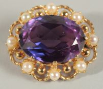 A 9CT GOLD AMETHYST AND PEARL INSET BROOCH.