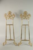 A LARGE PARI OF GILT METAL PICTURE EASLES. 80cm high.