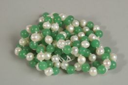 A LONG STRING OF PEARL AND GREEN JADE BEADS. 120cm long.