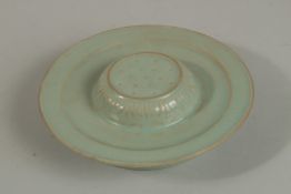 A CHINESE CELEDON GLAZE PORCELAIN STAND. 17.5cm diameter.