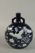 A CHINESE SACRIFICAL BLUE AND WHTIE PORCELAIN TWIN HANDLED MOONFLASK with pheonix decoration. 28cm
