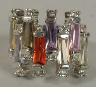 A .925 SILVER COLOURED STONE RING.