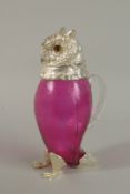 A PINK GLASS OWL CLARET JUG with silver plated head and feet. 29ins high.