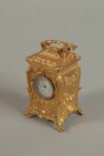 A MINIATURE BRASS ORNATE CARRIAGE CLOCK with acanthus scrolls and carrying handles. 7cm high