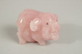 A CARVED ROSE QUARTZ PIG with blue eyes. 6ins.