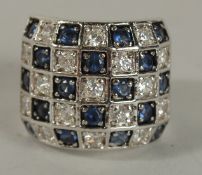 A .925 SILVER, DIAMANTE AND RED STONE RING.