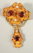 A VICTORIAN 18CT GOLD GARNET AND PEARL INSET BROOCH.