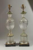 A GOOD PAIR OF FLUTED GLASS LAMPS on square marble bases, converted to electricity. 58cm high.