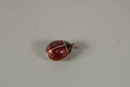 A SILVER AND ENAMEL LADYBIRD EGG PENDANT.