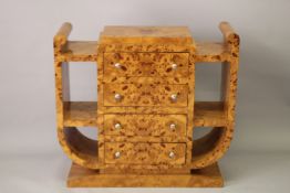 AN ART DECO DESIGN BLOND WOOD SIDE UNIT with four central drawers,flanked by open shelves. 3ft