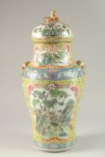 A CHINESE FAMILLE JAUNE PORCELAIN VASE AND COVER, painted with panels of various birds and flora,