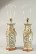 A FINE PAIR OF CHINESE CANTON FAMILLE ROSE PORCELAIN VASE LAMPS, painted with panels of figures,