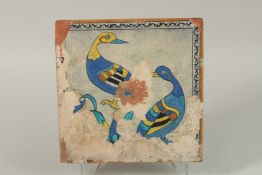 A FINE AND LARGE 18TH-19TH CENTURY MUGHAL INDIAN GLAZED POTTERY TILE, depicting two birds, 30cm x