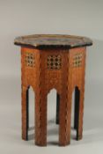 AN ISLAMIC MOORISH MOTHER OF PEARL AND EBONY INLAID OCTAGONAL TABLE, the top with mixed wood