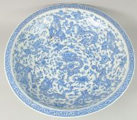 A VERY LARGE CHINESE BLUE AND WHITE PORCELAIN DRAGON DISH, with nine dragons amongst flowers and