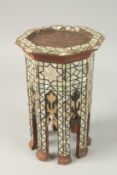 A MOORISH MOTHER OF PEARL INLAID OCTAGONAL APPRENTICE TABLE, 26cm high.