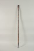 A CHINESE CARVED BAMBOO CANE, 88.5cm long.