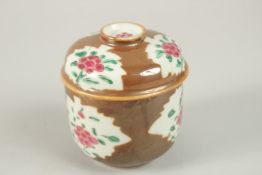 A CHINESE CAFE-AU-LAIT FAMILLE ROSE PORCELAIN CIRCULAR POT AND COVER, with enamel-painted floral