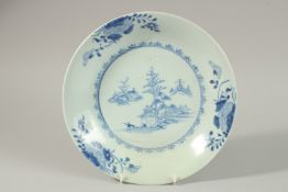 A CHINESE NANKING CARGO BLUE AND WHITE PORCELAIN PLATE, decorated with a central panel of a woodland