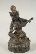 A BRONZE FIGURE OF SEATED DEITY PLAYING A MUSICAL INSTRUMENT, on a lotus base, 21.5cm high.