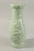 A CHINESE CELADON GLAZE PORCELAIN VASE, with carved dragon and ruyi decoration, the base with