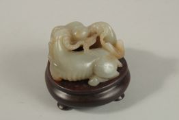 A CHINESE CARVED JADE GROUP DEPICTING THREE RAM'S, on a fitted hardwood stand, the base and stand