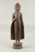 AN INDIAN CARVED WOOD STANDING BUDDHA UPON A LOTUS BASE, with applied coloured glass to the robes,