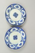 A PAIR OF PERSIAN SAFAVID BLUE AND WHITE PORCELAIN PLATES, each with mark to base, 21cm diameter.