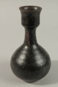 AN 18TH-19TH CENTURY BLACK GLAZE POTTERY VASE, 19.5cm high.