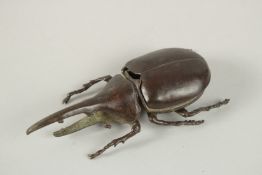 A BRONZE OKIMONO OF A RHINOCEEROS BEETLE.