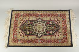 A FINE TURKISH HEREKE SILK RUG, 85cm x 53cm.