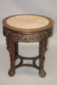A CHINESE CARVED HARDWOOD AND MARBLE TOP CIRCULAR URN STAND, 19TH CENTURY, with inset pink marble
