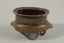 A CHINESE OVAL-FORM BRONZE CENSER, with lion head terminals and raised on three naturalistic feet,