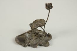 A BRONZE OKIMONO OF A LOTUS WITH FROG ON A LILYPAD.