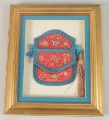 A CHINESE FRAMED EMBROIDERED SILK PURSE.