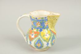 AN OTTOMAN TURKISH KUTAHYA GLAZED POTTERY JUG, 13cm high.