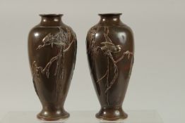 A FINE PAIR OF JAPANESE MEIJI BRONZE VASES, with mixed metal overlaid decoration depicting birds
