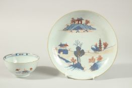 AN 18TH CENTURY CHINESE BLUE AND RED PORCELAIN BOWL AND DISH, the dish painted with temples and