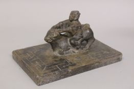 A CHINESE CARVED HARDSTONE FIGURAL GROUP of a man riding an oxen upon a key-carved rectangular base,